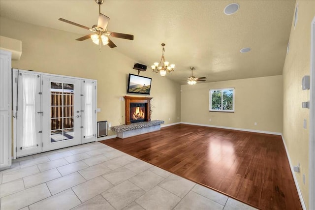 unfurnished living room featuring ceiling fan, lofted ceiling, and light tile patterned flooring