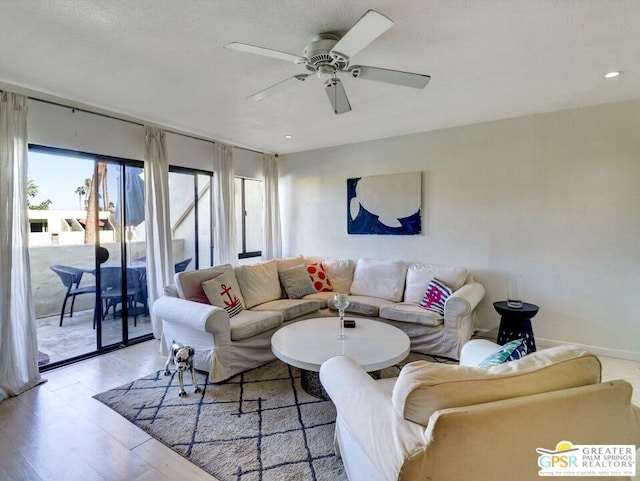 living room featuring light hardwood / wood-style floors and ceiling fan