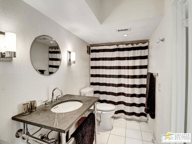 bathroom with toilet, tile patterned flooring, and vanity