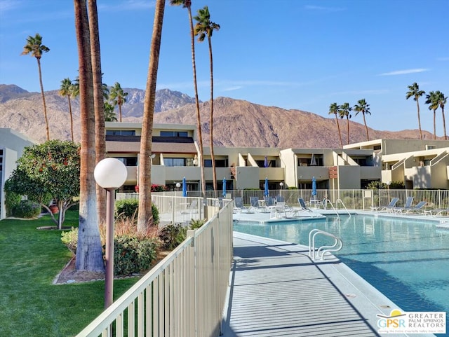 view of swimming pool with a mountain view