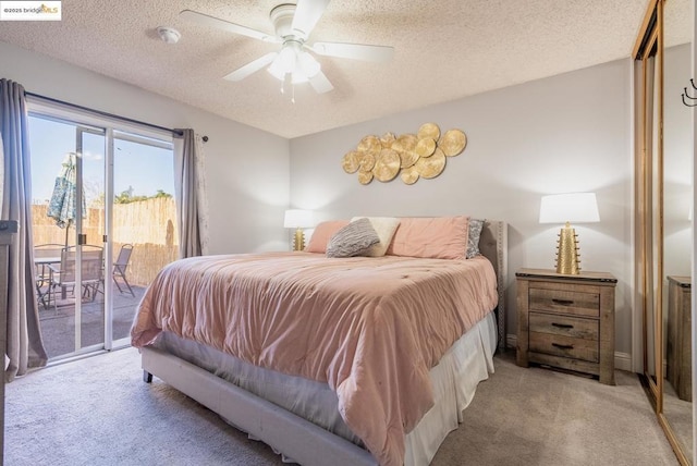 bedroom with access to exterior, ceiling fan, light colored carpet, and a textured ceiling