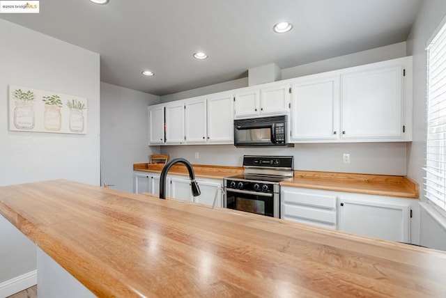 kitchen featuring white cabinets, electric range, and plenty of natural light