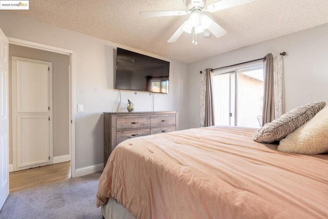 bedroom with carpet flooring, a textured ceiling, and ceiling fan