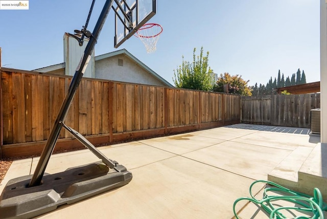 view of patio with basketball hoop