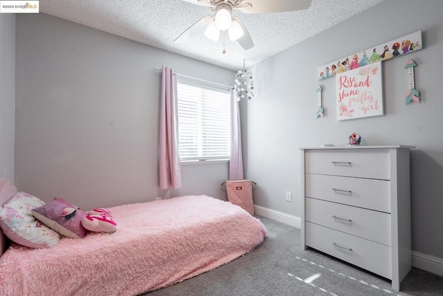 carpeted bedroom featuring a textured ceiling and ceiling fan