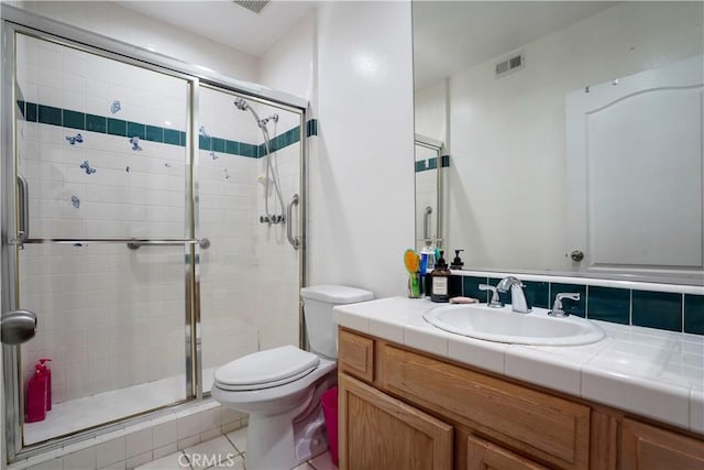 bathroom featuring decorative backsplash, tile patterned flooring, vanity, toilet, and a shower with door