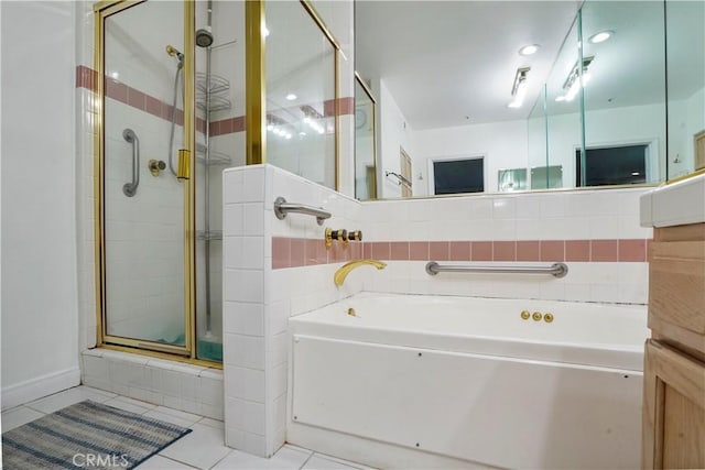 bathroom with shower with separate bathtub and tile patterned flooring