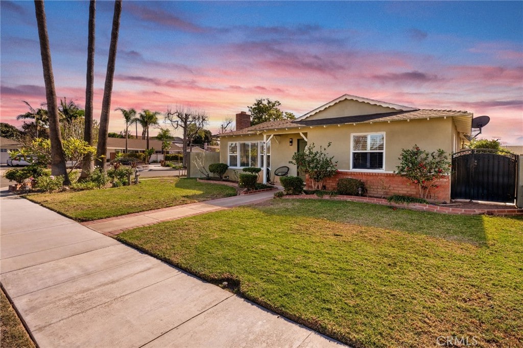 bungalow-style house with a yard