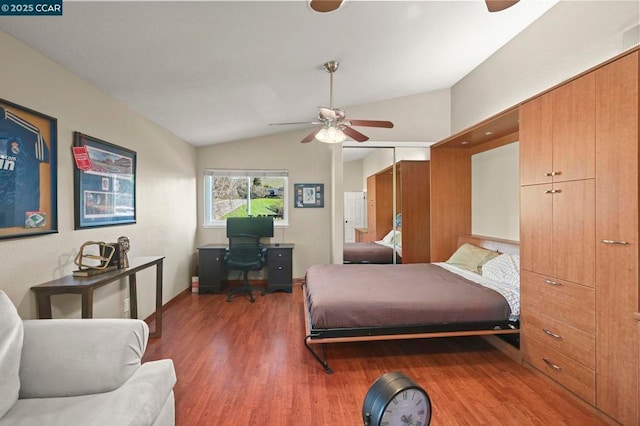 bedroom with vaulted ceiling, dark hardwood / wood-style floors, ceiling fan, and a closet