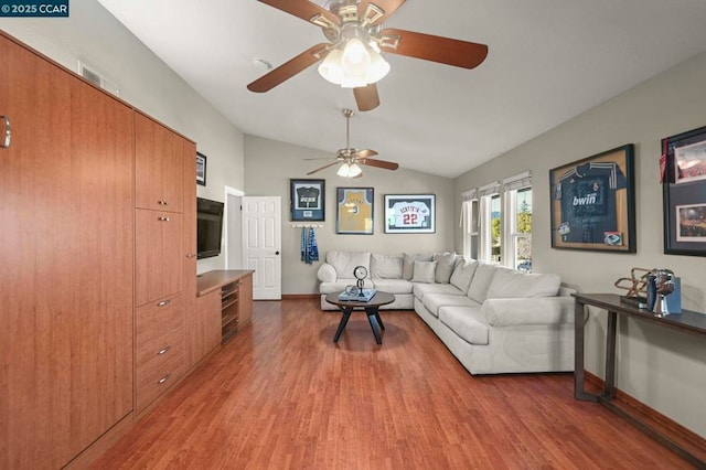 living room with hardwood / wood-style flooring and vaulted ceiling