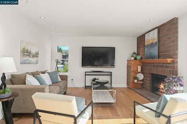 living room featuring light hardwood / wood-style flooring and a fireplace