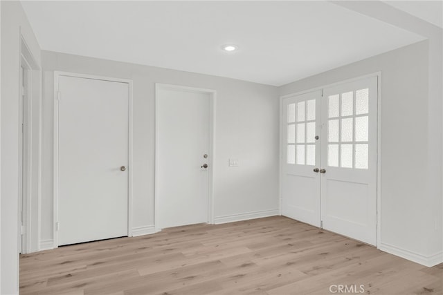 interior space featuring french doors and light hardwood / wood-style floors