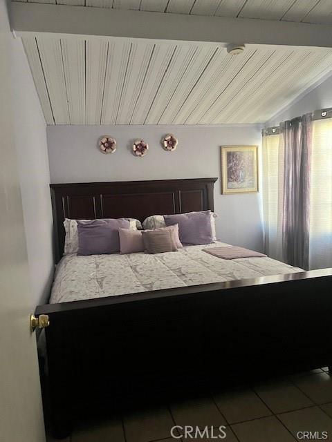 bedroom featuring light tile patterned flooring