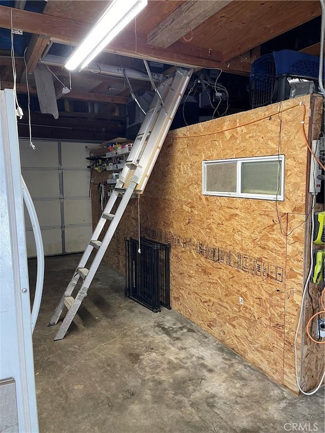 basement with white refrigerator