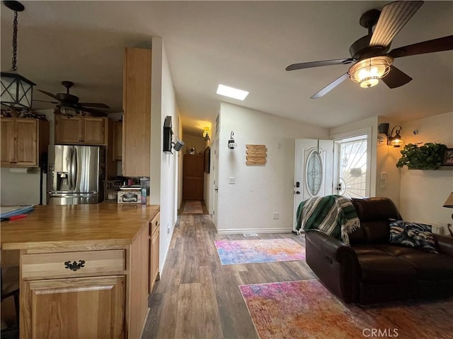 living room with vaulted ceiling, hardwood / wood-style floors, and ceiling fan