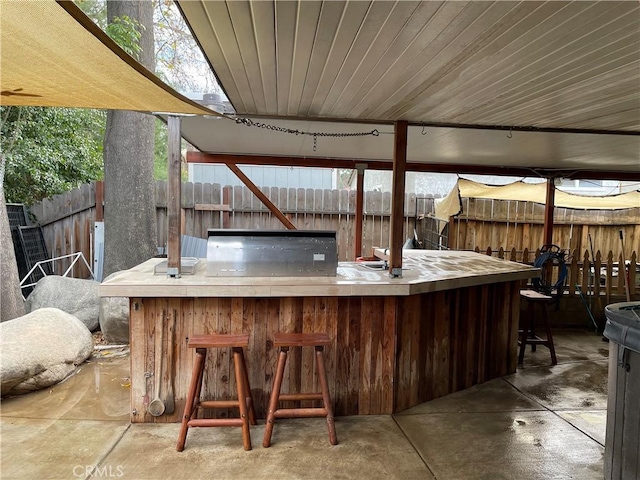 view of patio / terrace featuring an outdoor bar