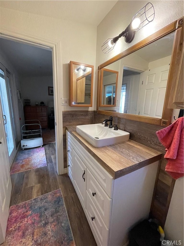 bathroom with vanity and hardwood / wood-style floors