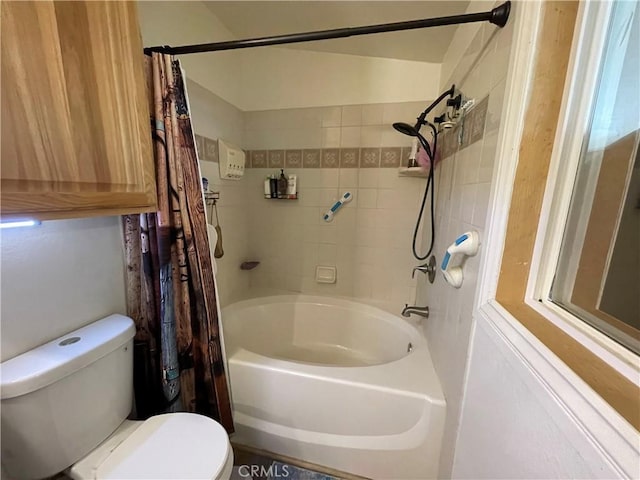 bathroom featuring toilet and shower / bath combo with shower curtain