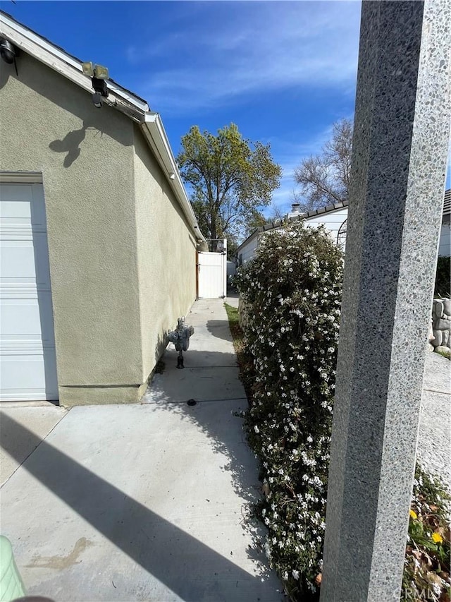 view of side of home featuring a garage