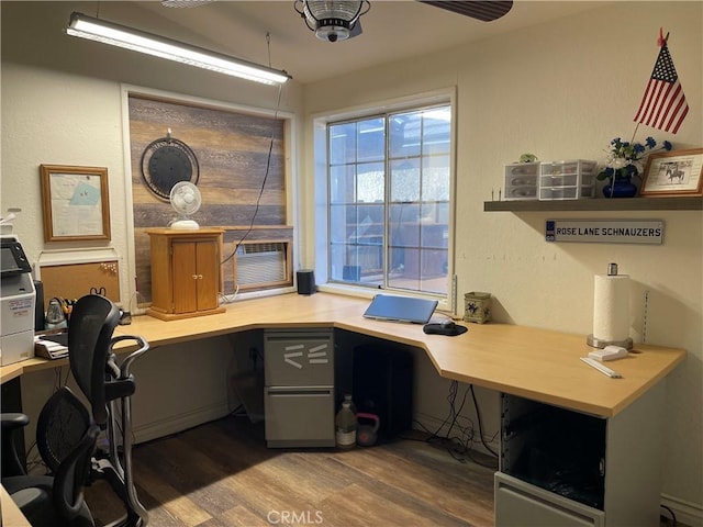 home office featuring dark wood-type flooring and built in desk