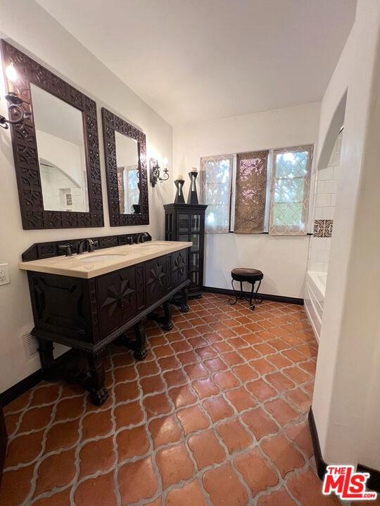 bathroom with vanity and a bathtub