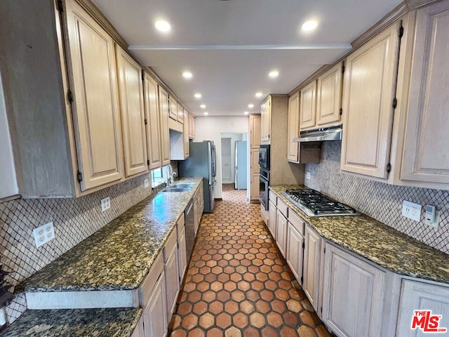 kitchen featuring decorative backsplash, light brown cabinetry, dark stone counters, and stainless steel appliances