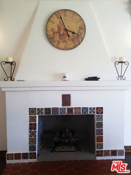 interior details with a tiled fireplace