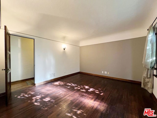 empty room with hardwood / wood-style flooring