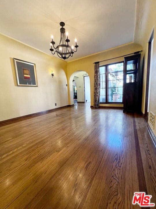 interior space with a notable chandelier and dark hardwood / wood-style floors