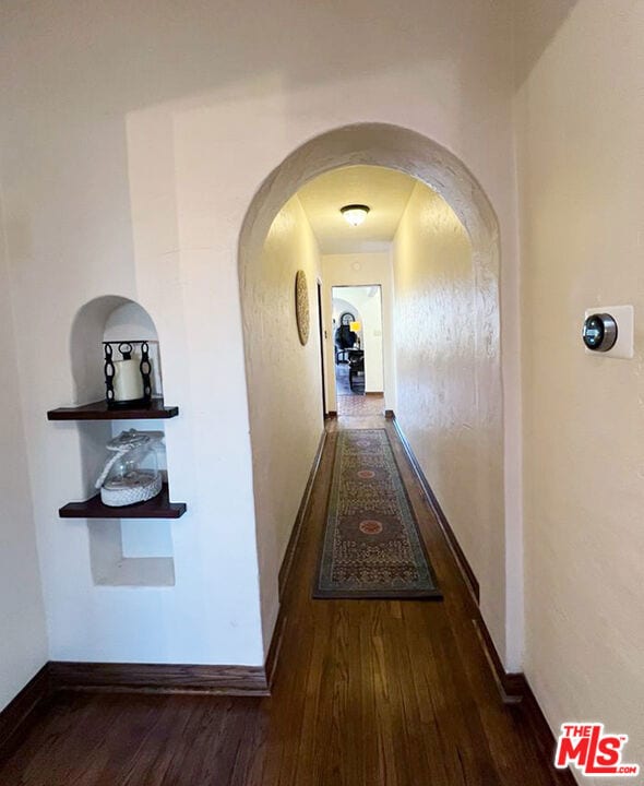 corridor featuring dark hardwood / wood-style floors