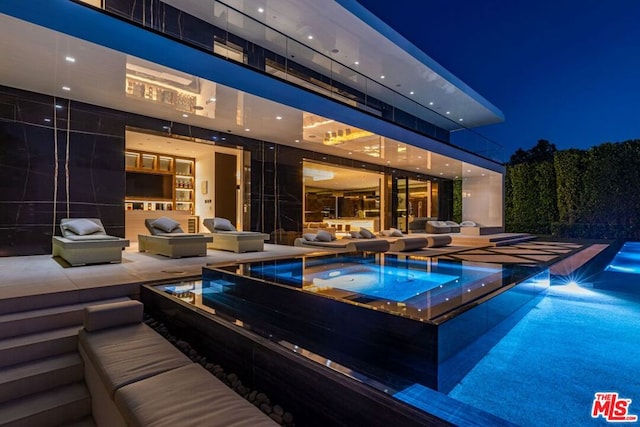 view of pool featuring an in ground hot tub and an outdoor hangout area