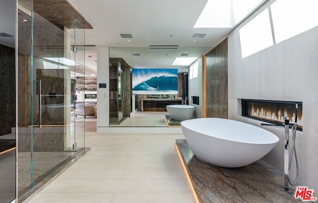 bathroom featuring shower with separate bathtub