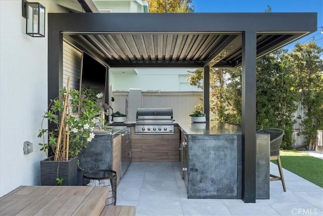 view of patio with an outdoor kitchen and area for grilling