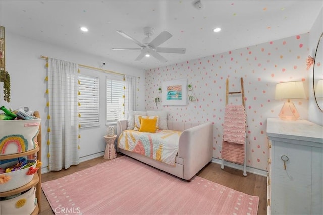 bedroom with ceiling fan and light hardwood / wood-style floors