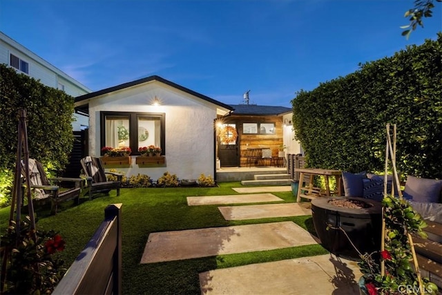 exterior space with an outdoor fire pit and a patio area