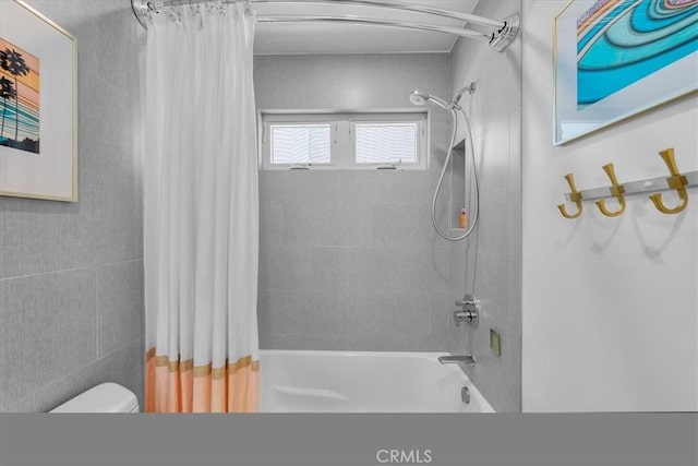 bathroom with shower / bath combo with shower curtain and toilet