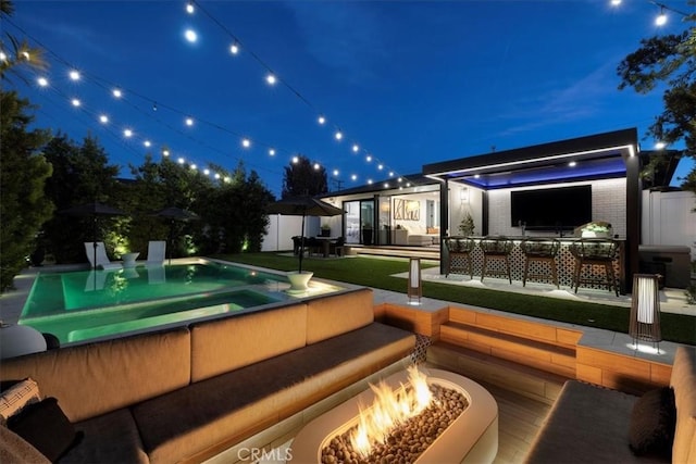 exterior space with a patio area and an outdoor living space with a fire pit