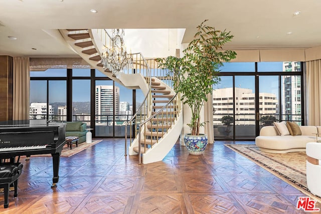 interior space featuring plenty of natural light, parquet floors, and an inviting chandelier