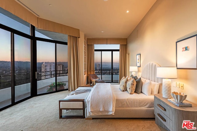 carpeted bedroom with access to exterior and floor to ceiling windows