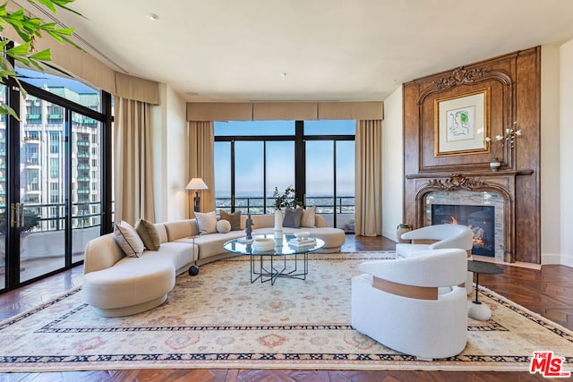 living room with a healthy amount of sunlight, a fireplace, and parquet flooring