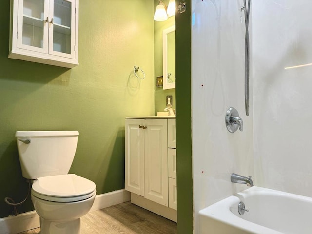 full bathroom featuring hardwood / wood-style flooring, vanity, toilet, and shower / washtub combination