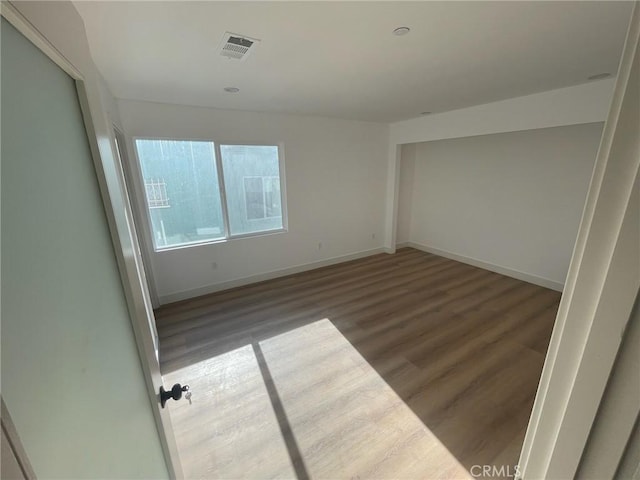 spare room featuring dark hardwood / wood-style flooring