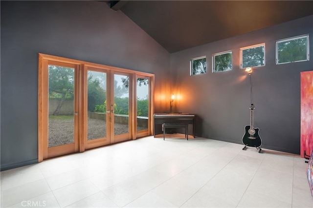 entryway with beam ceiling and high vaulted ceiling