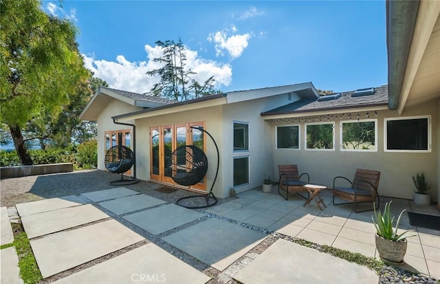 back of property with french doors and a patio area