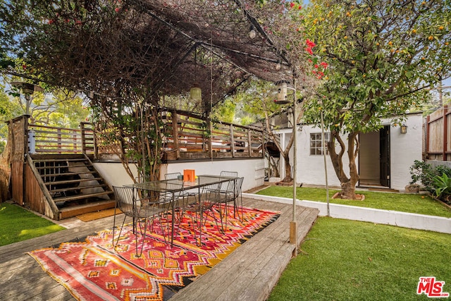 view of property's community with a wooden deck and a yard