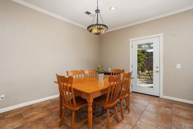 dining room featuring ornamental molding and tile patterned flooring