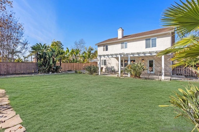 back of house featuring a pergola, a lawn, and a patio