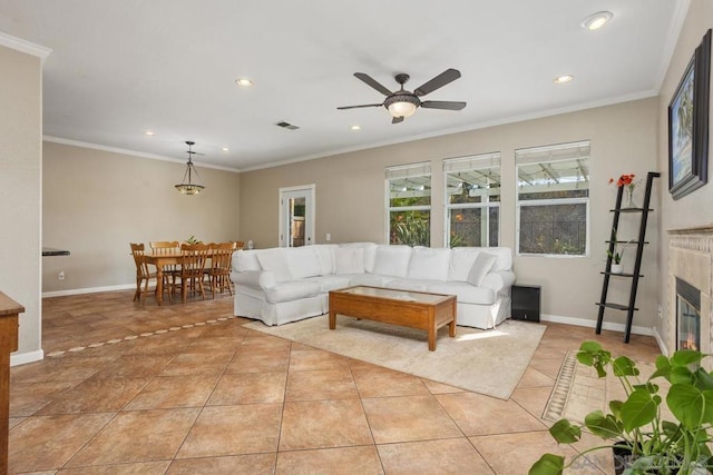 tiled living room featuring a premium fireplace, ornamental molding, and ceiling fan