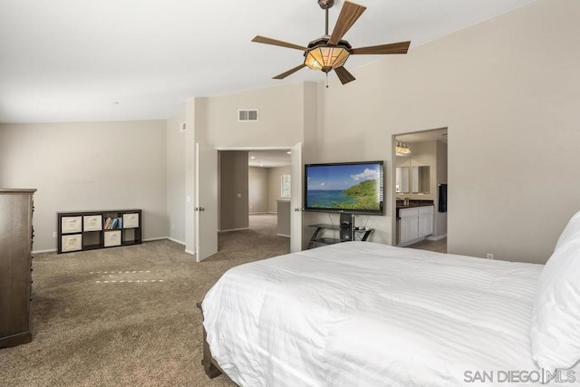 bedroom featuring ensuite bath, vaulted ceiling, ceiling fan, and carpet flooring