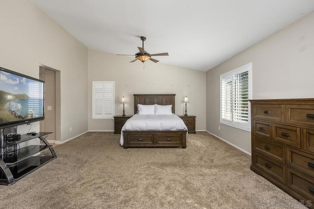 carpeted bedroom with ceiling fan and lofted ceiling